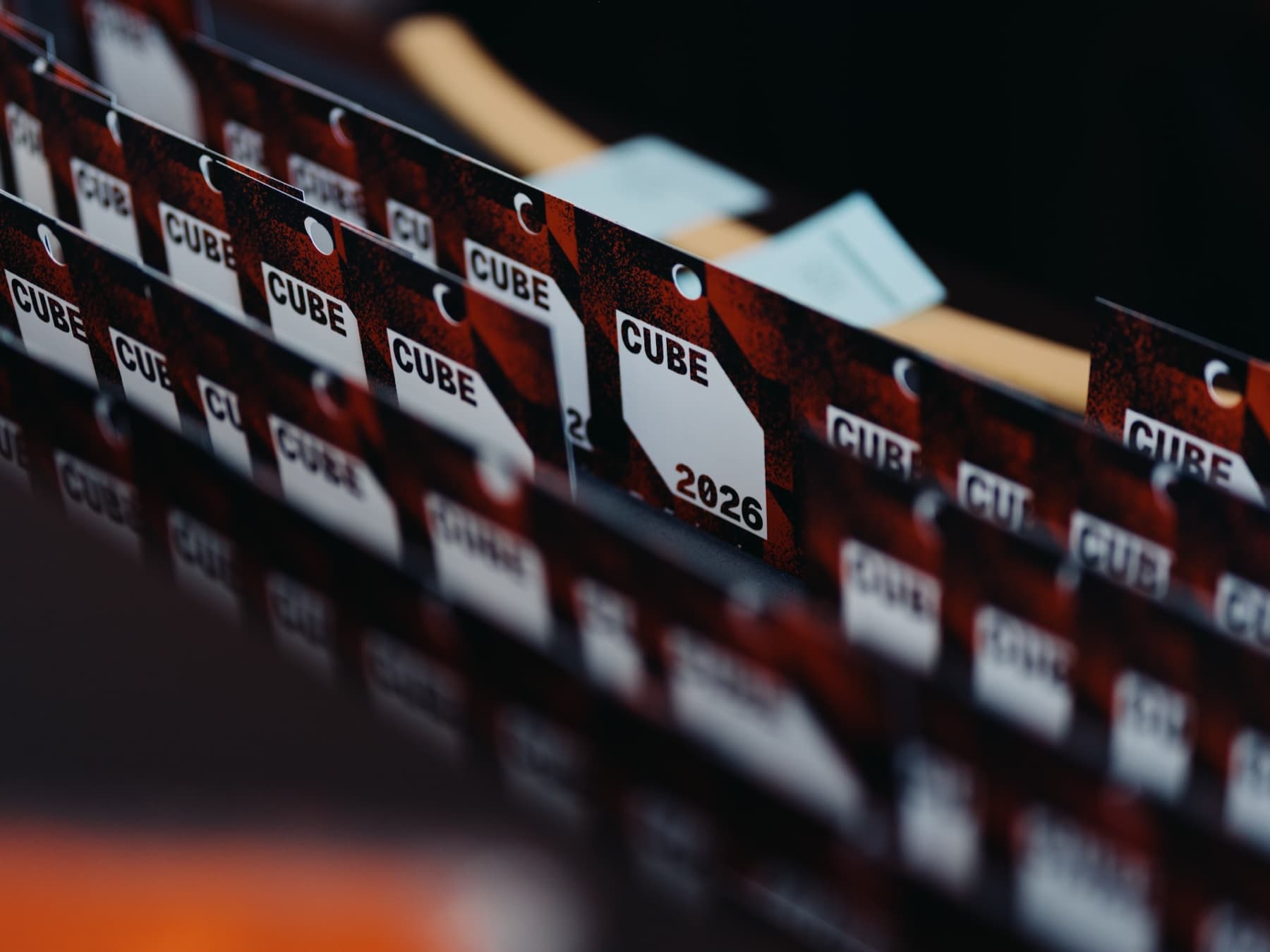 Rows of CUBE 2026 guest badges carrying the event identity