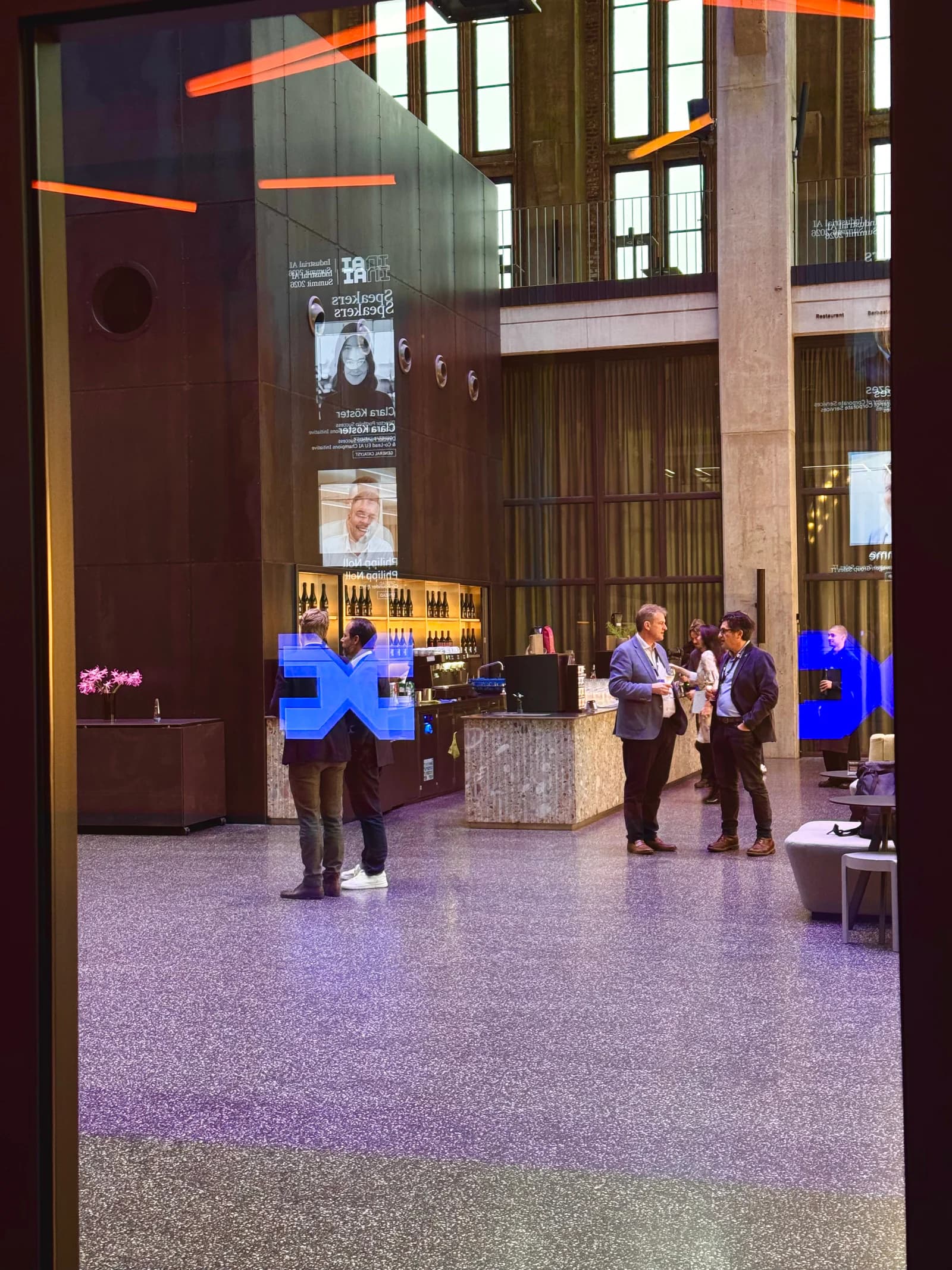 Industrial AI Summit speaker screens reflected across the Bergson foyer